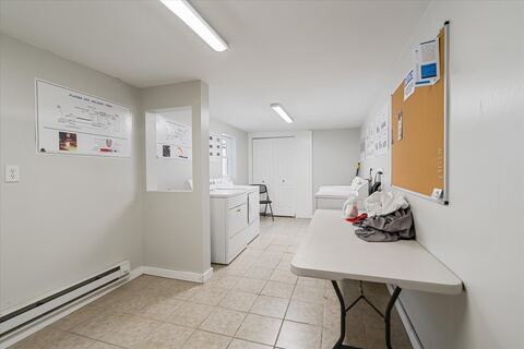 Laundry room with folding table and bulletin board