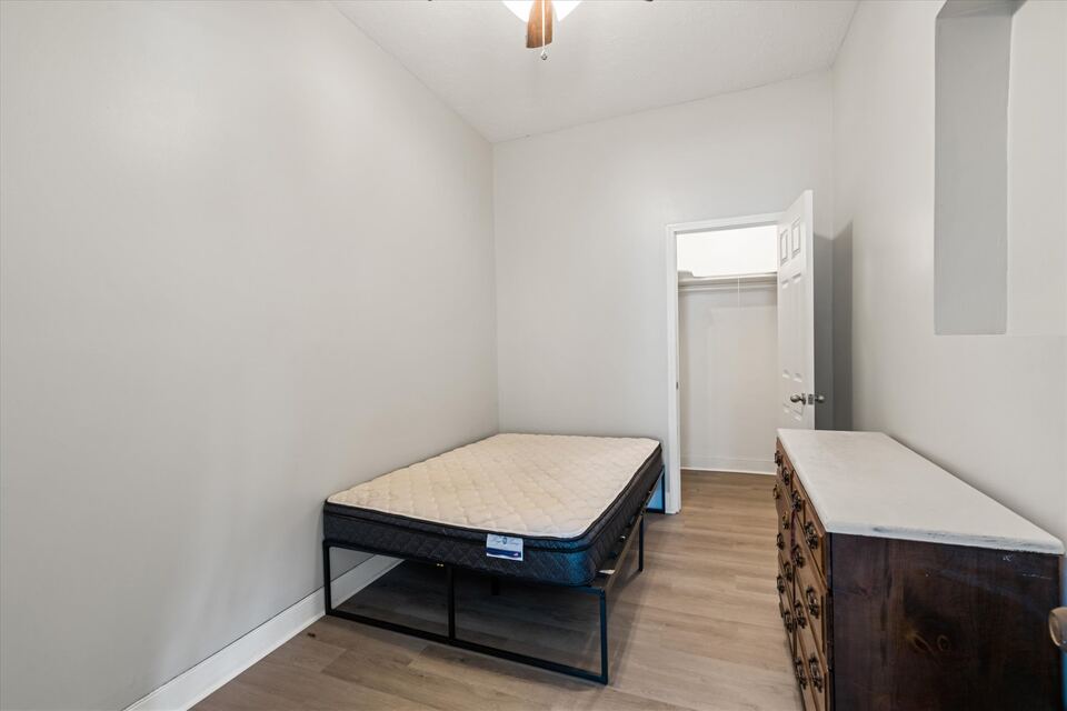 Freshly remodeled furnished bedroom at The Hatfield House with bed and dresser