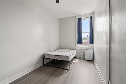 Bright furnished bedroom with a large window