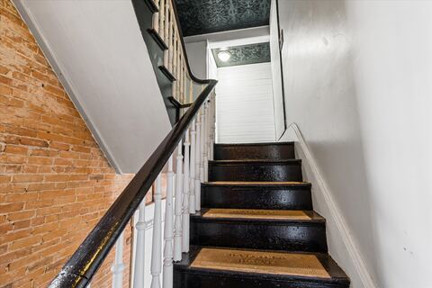 Stairwell framed by original hand-laid brick