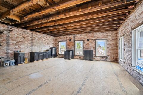 Third floor with original brick walls and timber ceiling joists