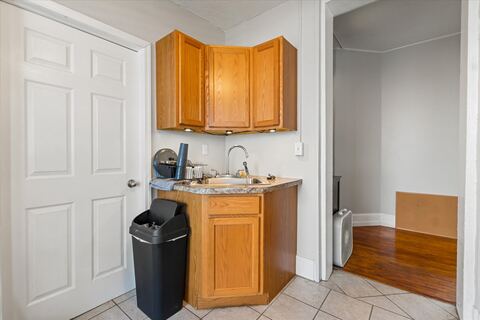 Compact kitchenette with sink and cabinets