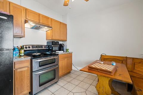Kitchen with stainless range and game table