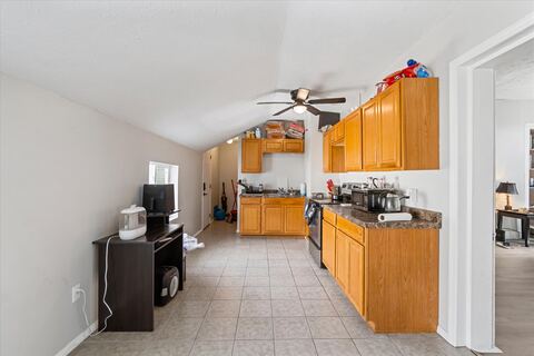 Shared kitchen with wood cabinets and full appliances