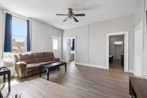 Bright living room with couch and new plank flooring